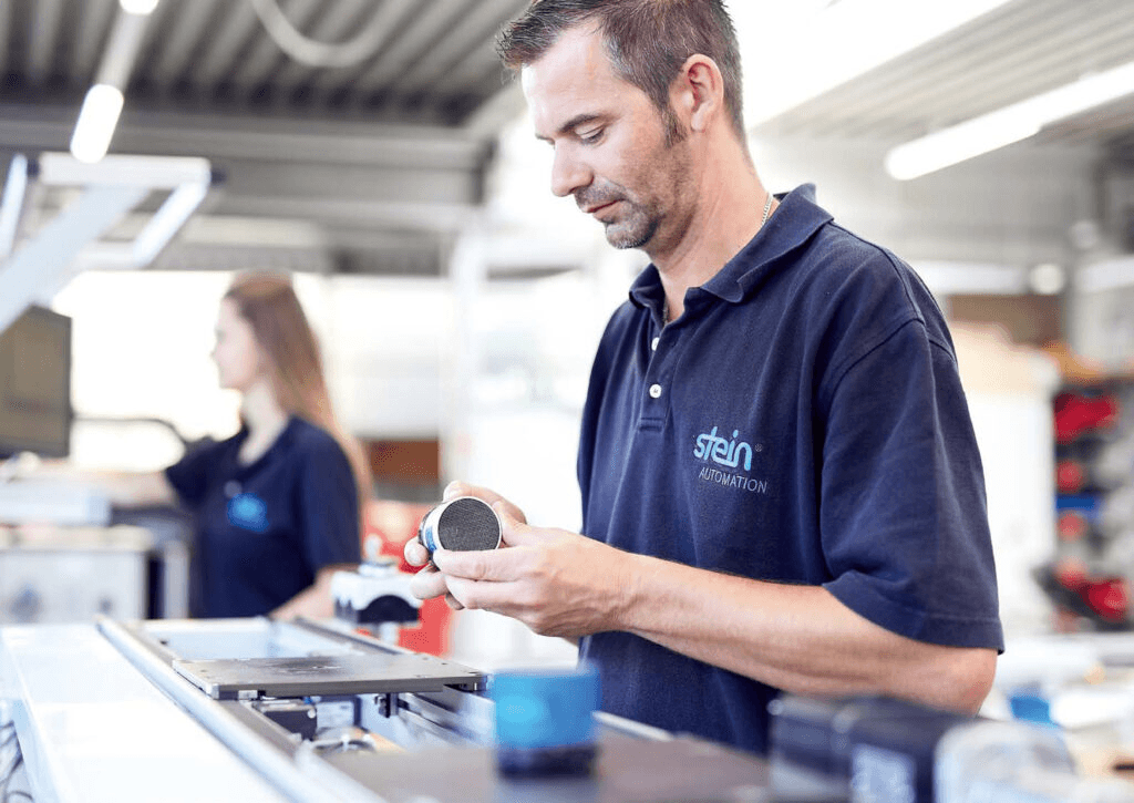 STEIN Automation Mann Montage Mitarbeiter bei der Montage an einem System von STEIN Automation